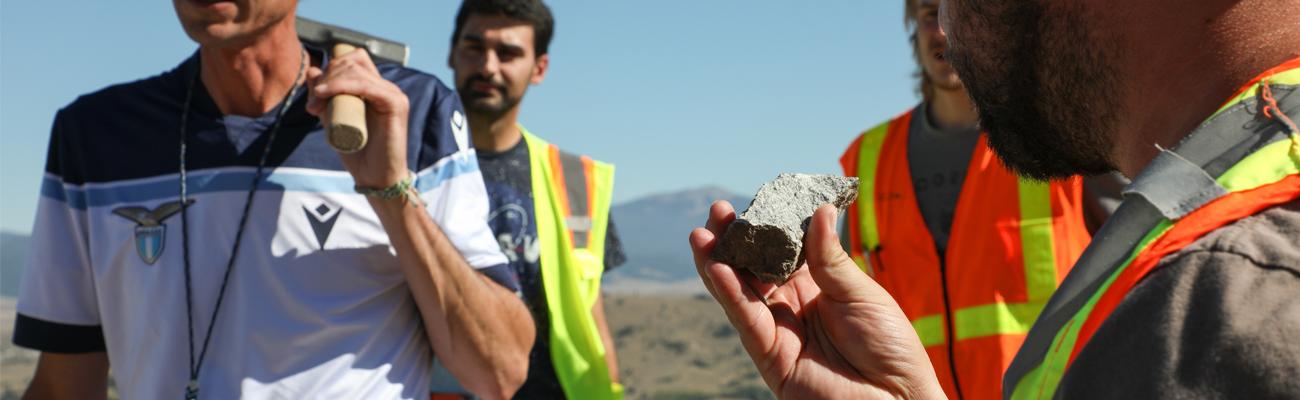 Student inspecting a rock