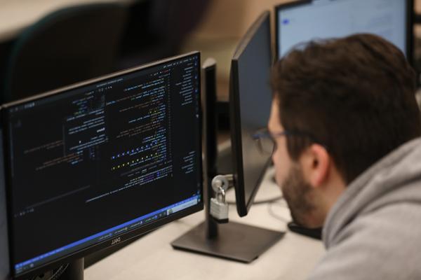 Man programming in a computer lab