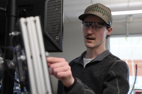 Mechanical engineering student pointing at a computer screen